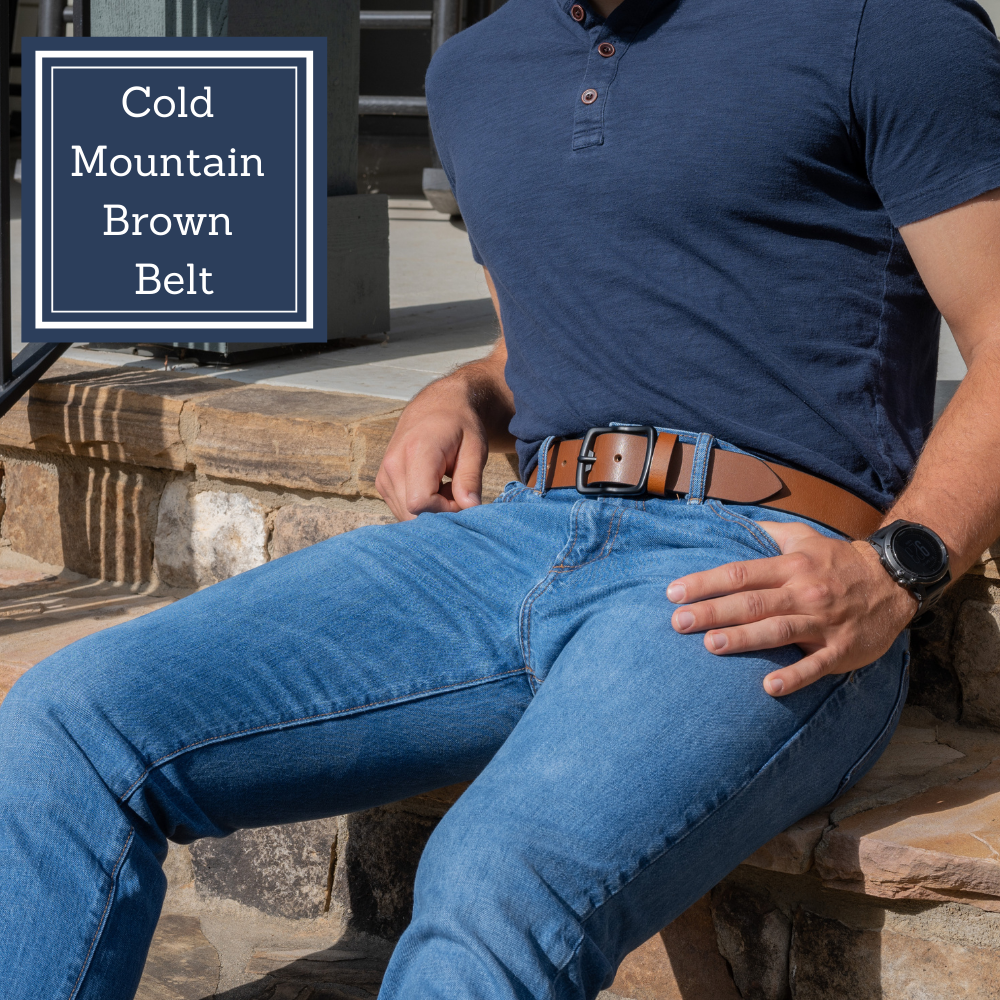 Image of model wearing Cold Brown Leather belt with black nickel free buckle. Text on image says Cold Mountain Brown Belt. Full Grain Leather. Nickel Free Buckle.