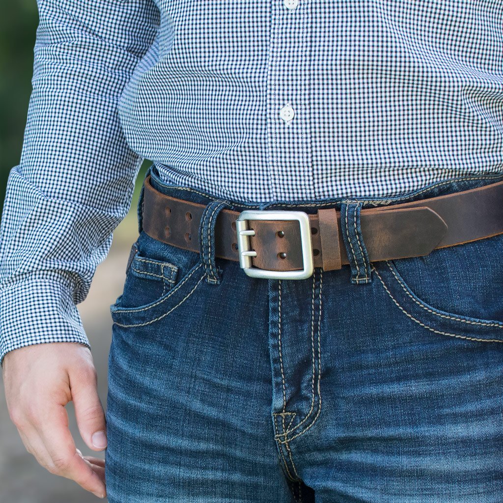 Ridgeline Trail Distressed Leather Belt (Brown) on a model with jeans. Silver tone buckle, 2 prongs.