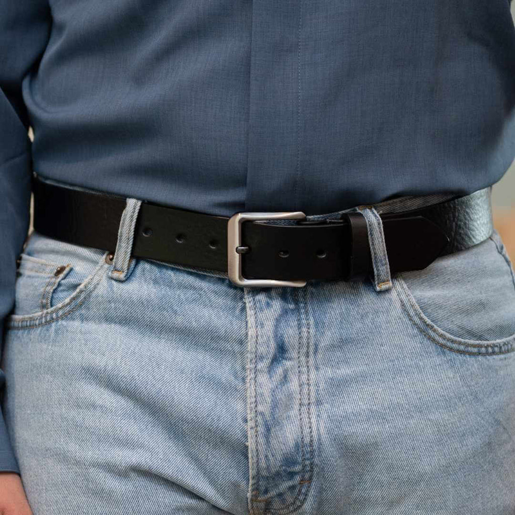 New River Black Leather Belt on model wearing blue shirt and blue jeans. Hypoallergenic.