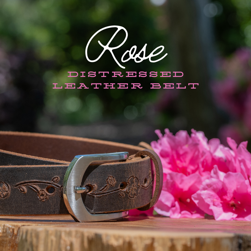 Rose distressed leather belt with rose embossing all the way around the belt. Pink azalea in background
