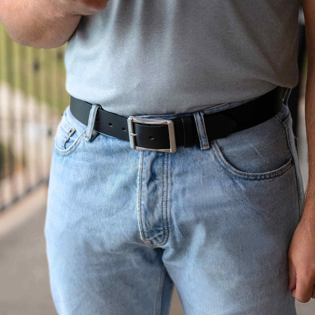 Site Manager Black Leather Belt on model wearing blue jeans and t-shirt. Stainless Steel buckle