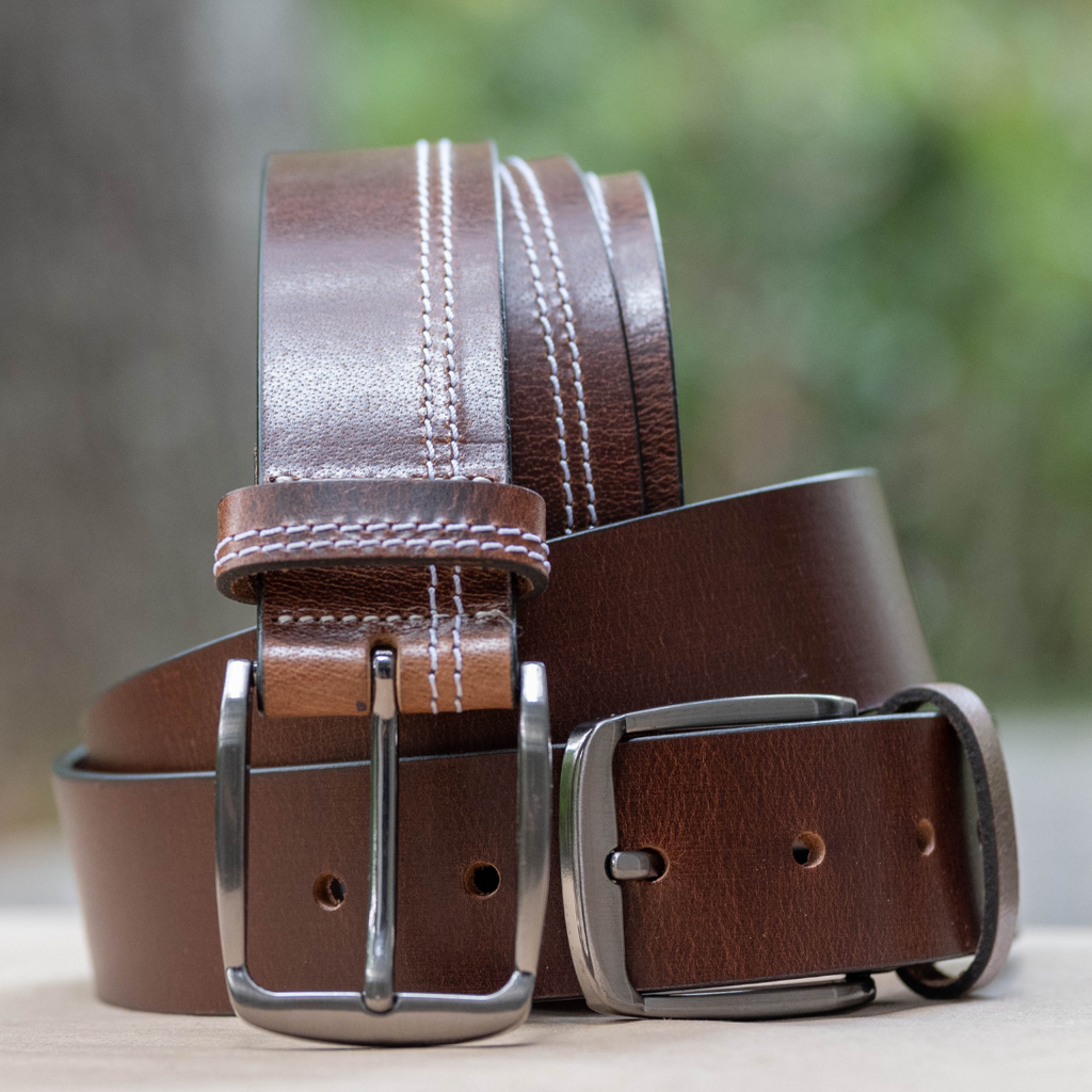 Millennial Brown and Brown Stitched Leather Belt Set by Nickel Zero. Outside setting. 2 brown belts.