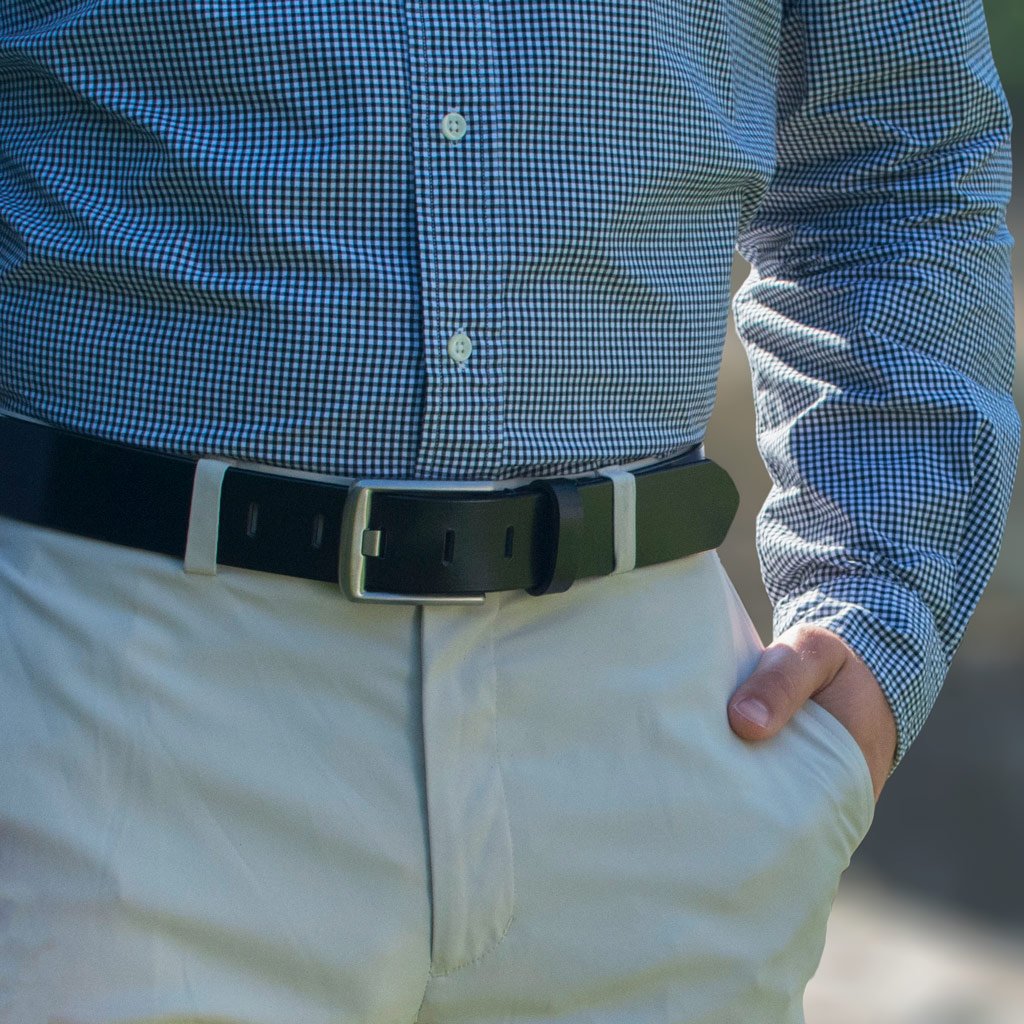 Titanium Wide Pin Black Belt on model in khakis. Solid black strap with dress-casual buckle.