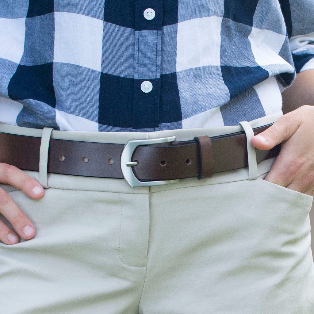 Picture of the Stone Mountain Brown Leather Belt on a female model wearing khaki pants.  Brown Leather strap with nickel free silver arched buckle.  Hypoallergenic.