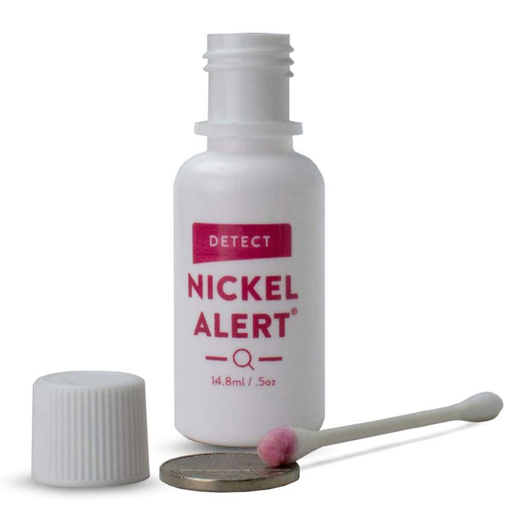 Image of Nickel Alert bottle with a nickel and a cotton swab showing a positive test.  The swab turn pink indicating nickel is present.