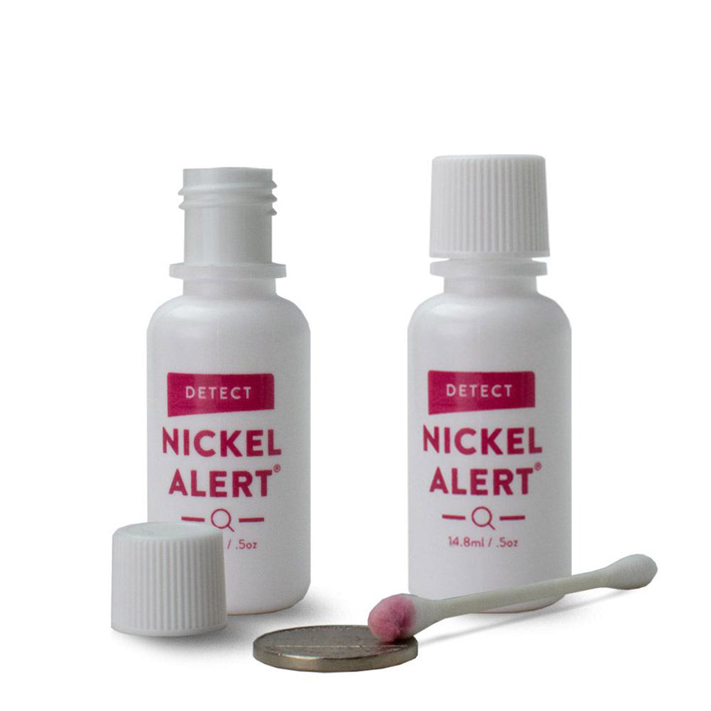 Image of 2 bottles of Nickel Alert, a nickel and a cotton swab with a pink color indication a positive reaction.- easy, effective, detect nickel in metal within seconds.  Made in USA