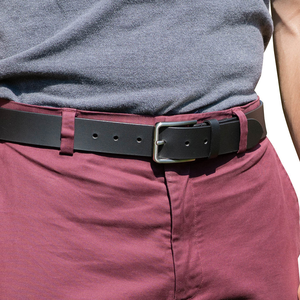 Slick City Black Leather Belt on model in salmon colored pants. Great casual belt; 1⅜" (35 mm) wide.